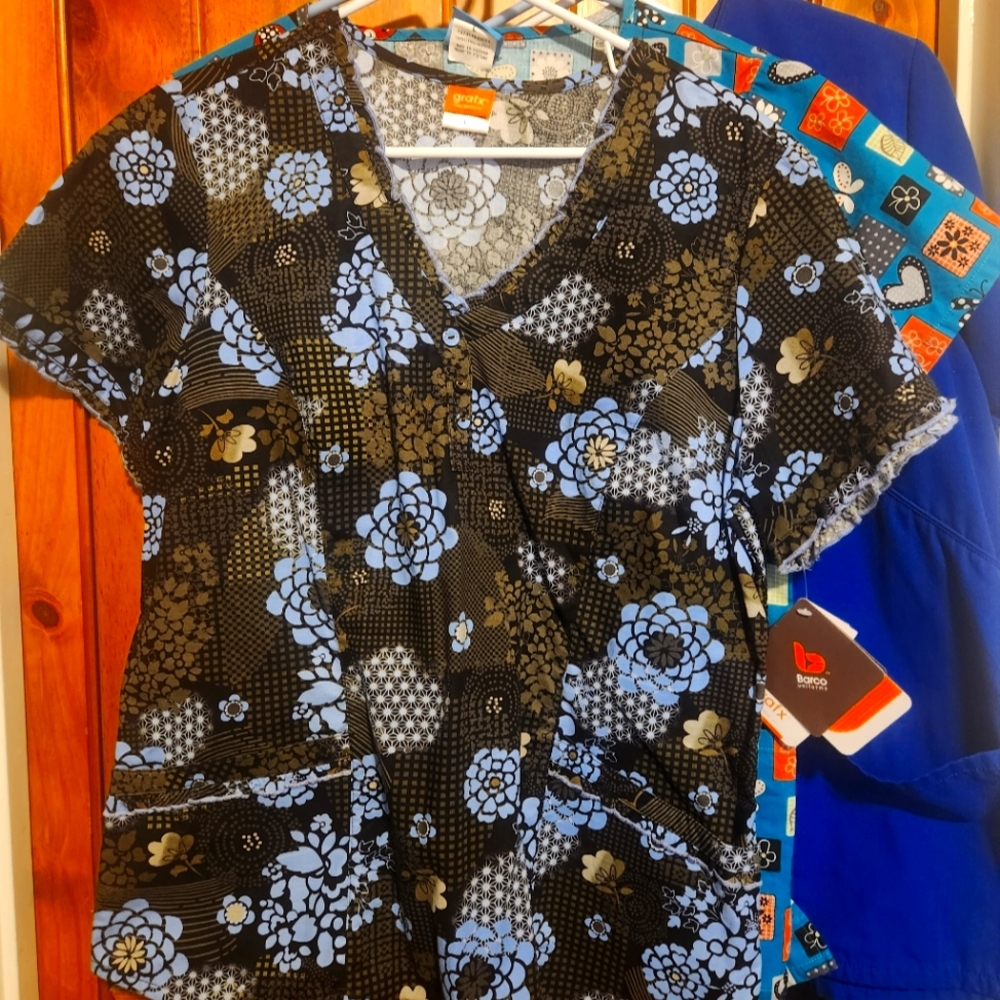 13 Ladies scrub tops, size large. This is sold as a lot.